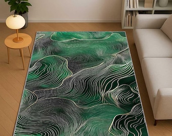 May include: A rectangular area rug with a green and black abstract design. The rug features a wavy pattern with gold-colored lines. The rug is placed on a wooden floor in a living room setting.
