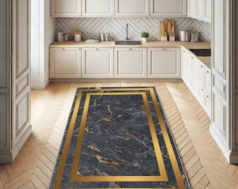 May include: A rectangular rug featuring a dark grey marble design with a gold border. The rug is positioned on a wooden floor within a kitchen, enhancing the room's aesthetic appeal.