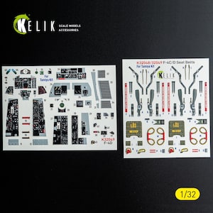 May include: Two decal sheets for scale model accessories. One sheet features cockpit details, the other seat belts, with text including "For Tamiya Kit" and "K32049 F-4D". The scale is 1/32.
