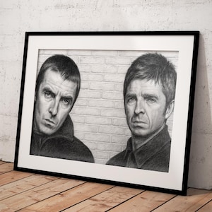 May include: Black framed pencil portrait of two men, each with short hair and serious expressions. The artwork is set against a brick wall background. The frame is leaning against a white wall and wooden floor.