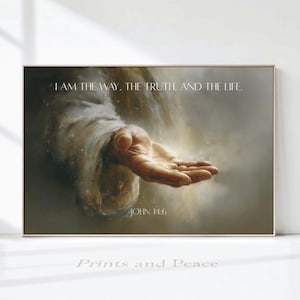 May include: A rectangular wall art print featuring a painting of an outstretched hand emerging from soft, ethereal light and shadows. The text "I AM THE WAY, THE TRUTH, AND THE LIFE." is printed at the top, with "JOHN 14:6" centered at the bottom.
