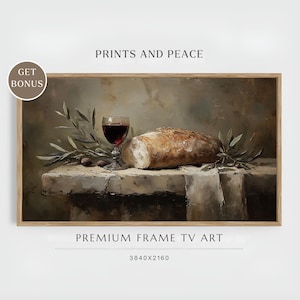 Puede incluir: Una impresión enmarcada que presenta una naturaleza muerta con una hogaza de pan, una copa de vino tinto y aceitunas sobre una superficie de piedra. Ramas de olivo están dispuestas alrededor de la comida y la bebida. El texto "PRINTS AND PEACE" y "PREMIUM FRAME TV ART" son visibles.
