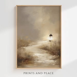 May include: A framed landscape print with a path leading to a glowing lantern. The artwork features a muted color palette of beige, brown, and gray, with the text "PRINTS AND PEACE" at the bottom.