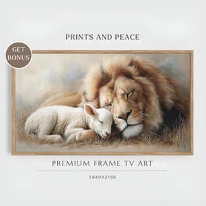 May include: A framed print depicting a lion and a lamb in a peaceful embrace. The lion has a golden mane, and the lamb is white. The image includes the text "PRINTS AND PEACE" and "PREMIUM FRAME TV ART". The frame is a light brown colour.