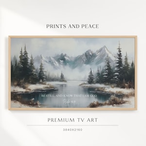 May include: A framed landscape digital print featuring snow-covered mountains, dark evergreen trees, and a calm lake. The text reads: PRINTS AND PEACE, BE STILL, AND KNOW THAT I AM GOD, Psalm 46:10, PREMIUM TV ART, and 3840x2160.