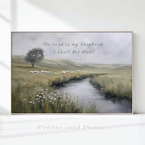 May include: A landscape wall art print featuring a grassy meadow with a winding stream, a lone tree, and a small flock of sheep. The text reads: The Lord is my Shepherd; I Shall Not Want. PSALM 23:1-2. The colour palette includes muted greens, browns, and greys.