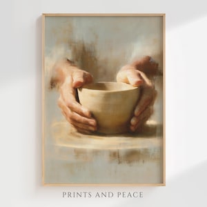 May include: A vertical wall art print featuring an oil painting style depiction of two hands cupping a plain, light beige ceramic bowl. The background consists of soft, blended brushstrokes in shades of cream, tan, and light gray. Text reads PRINTS AND PEACE.