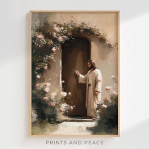 May include: A framed art print depicting a figure in a white robe knocking on a wooden door. The scene is surrounded by pink flowers and greenery. The text "PRINTS AND PEACE" is printed at the bottom of the frame.