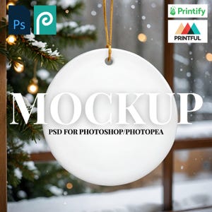 May include: A white, round ornament mockup with the word "MOCKUP" in large, bold letters. Below, the text reads "PSD FOR PHOTOSHOP/PHOTOPAE". The ornament hangs from a gold string against a snowy background.