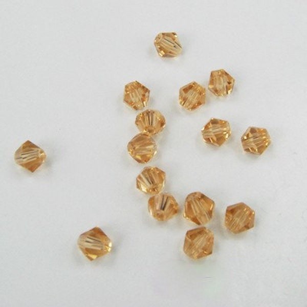 25 Light Brown/ Amber bicone pieces 4mm Crystals beads... destash sale price ....  item 1119A27