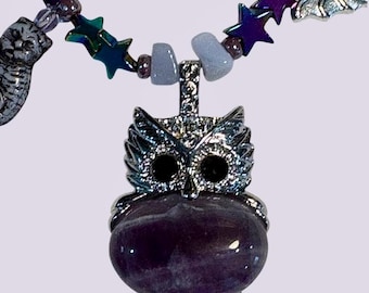 Amethyst stones and colors along with spooky charms in this Halloween themed Necklace