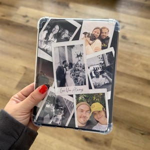 May include: Clear protective case for a tablet, filled with black and white photos. The photos depict various people and events, including a wedding and selfies. The phrase "Love You Always" is written on one of the photos.