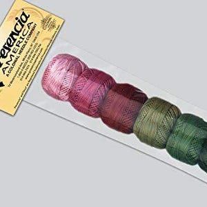 May include: A package of Presencia America thread spools in a gradient of colors from pink to green. The label reads "Presencia America A Colonial Needle Company". The spools are in a clear plastic sleeve.