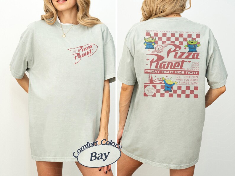 May include: A light green t-shirt with the Pizza Planet logo on the front and back. The back of the shirt features the Pizza Planet logo, alien characters, and text that reads "Friday Night Kids Night."