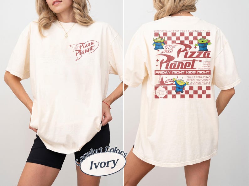 May include: Ivory-colored t-shirt with the Pizza Planet logo on the front and back. The back features the Pizza Planet logo, aliens, and text. The shirt is a Comfort Colors brand.