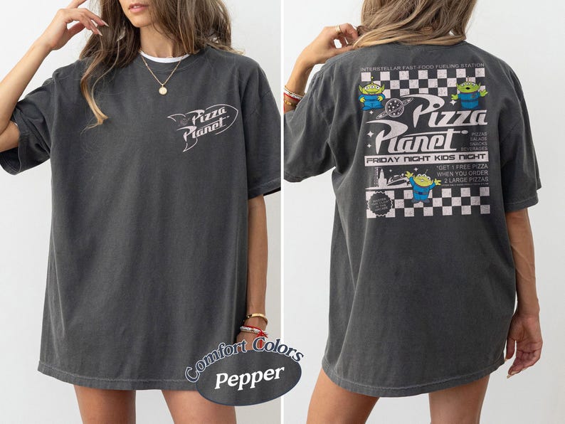 May include: Dark grey t-shirt with the "Pizza Planet" logo on the front and a graphic on the back. The back graphic features the text "Pizza Planet" with alien characters and the text "Friday Night Kids Night".