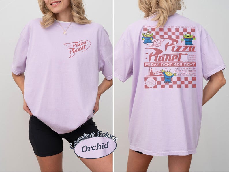 May include: Orchid-colored t-shirt with a Pizza Planet logo on the front and a graphic on the back. The back graphic features the Pizza Planet logo, aliens, and text. The shirt is a Comfort Colors brand.