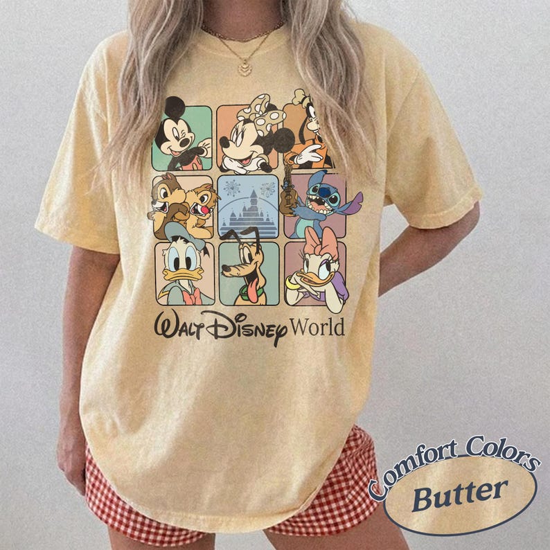 May include: Butter-colored t-shirt featuring a grid of Disney characters including Mickey Mouse, Minnie Mouse, and Stitch. The words "Walt Disney World" are printed below the grid. The shirt is a Comfort Colors brand.