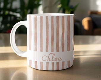 May include: White ceramic mug with a curved handle. The mug features vertical stripes in a soft, muted pink color. The name "Chloe" is printed in a delicate script font across the center of the mug.