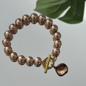Gold tone Pearl Beaded Bracelet with Shell Charm