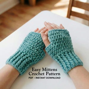 May include: A pair of teal blue fingerless mittens, crocheted with a textured stitch. The image includes the text "Easy Mittens Crochet Pattern" and "PDF - INSTANT DOWNLOAD". The mittens are shown on a person's hands.