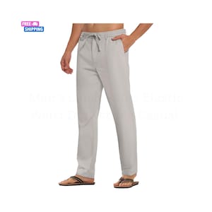 May include: Light gray elastic waist drawstring casual pants. The pants have a relaxed fit and a drawstring closure. The model is wearing brown and black sandals.