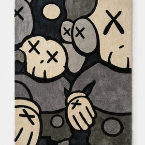 May include: A rectangular rug featuring a repeating pattern of abstract figures in shades of gray, black, and cream. The figures have X-shaped eyes and hands with X-shaped markings. The rug has a modern, cartoonish aesthetic.