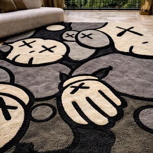 May include: A large area rug featuring a repeating pattern of cartoon-like characters in shades of gray, black, and cream. The rug has a plush texture and a modern design, suitable for a living room or bedroom.