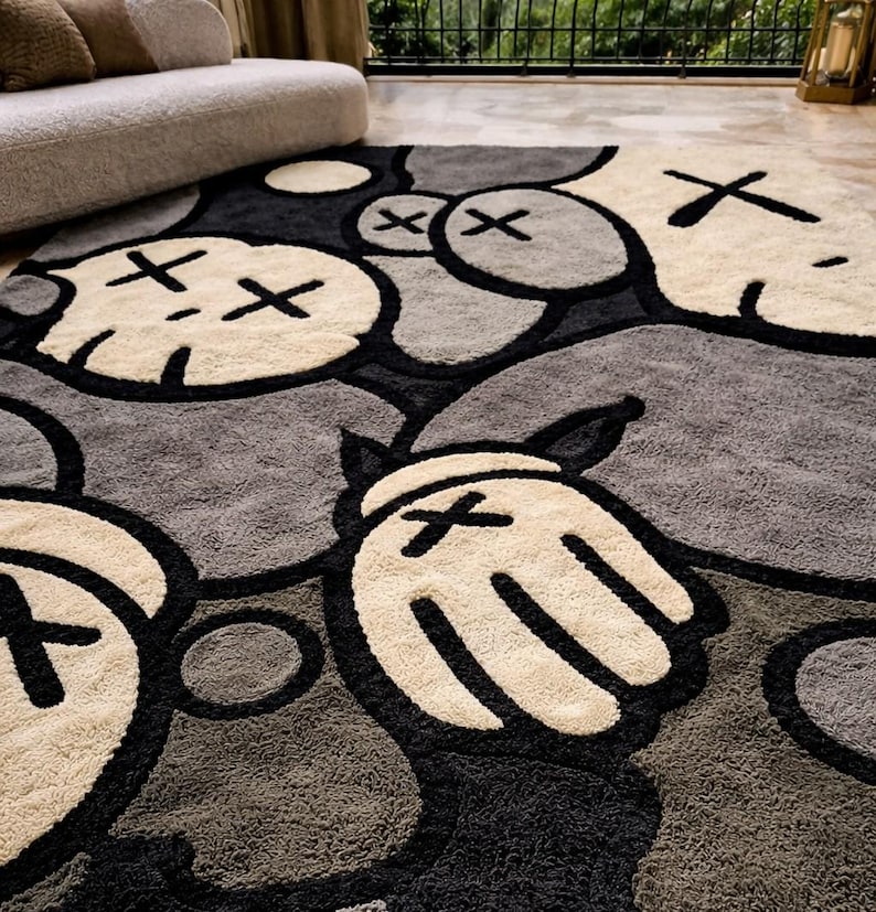May include: A large area rug featuring a repeating pattern of cartoon-like characters in shades of gray, black, and cream. The rug has a plush texture and a modern design, suitable for a living room or bedroom.