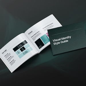 May include: An open book and a closed booklet on a dark background. The open book shows a logo with the text "Cross Church" and colour swatches. The booklet cover reads "Visual Identity Style Guide" in white text.