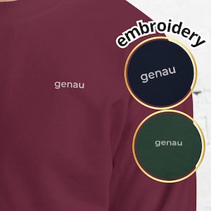 May include: A maroon sweatshirt with the word "genau" embroidered in white on the chest. The word "embroidery" is written above the two color swatches, one navy blue and one dark green, each with "genau" embroidered in white.
