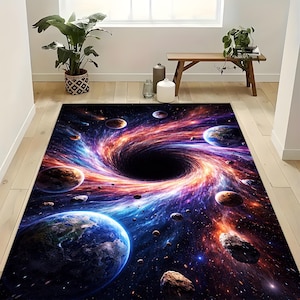May include: A rectangular area rug featuring a vibrant space scene with a black hole at the center. The design includes planets, asteroids, and swirling nebulae in shades of blue, orange, and purple.