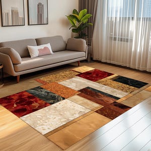 Può includere: Un tappeto rettangolare con un motivo geometrico. Il tappeto presenta una varietà di trame e colori, tra cui rosso, nero, beige e marrone. Il tappeto è posizionato su un pavimento in legno in un soggiorno.