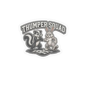 May include: A die-cut sticker featuring a black and white skunk and a grey rabbit standing on a patch of grass. Above the animals, the text THUMPER SQUAD is printed in a bold, arched, dark grey font with a white outline on a light grey background.