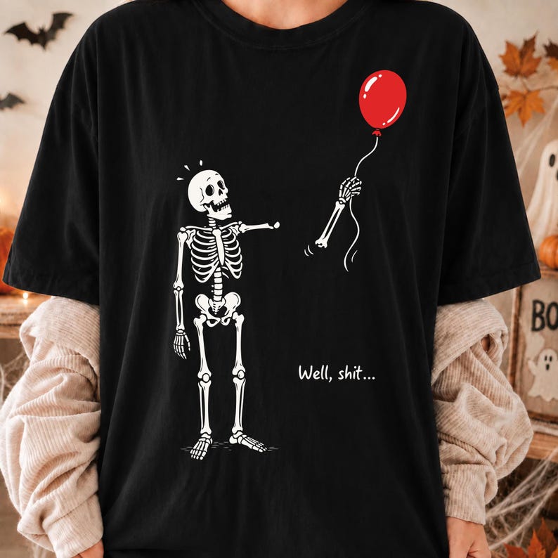 Black Halloween T-shirt mockup with funny skeleton lost balloon design and sarcastic Well Shit dark humor quote.