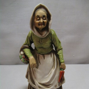 Figurine Bisque Porcelain Elderly Old Lady Carrying Carrots and Basket Vegetables  Green Blouse Brown Skirt White Apron E3429  Inarco 1970