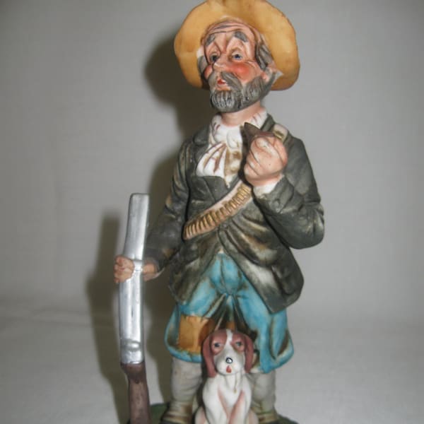 Porcelain Ceramic Bisque Figurine Man Smoking Pipe Holding Rifle Sitting Brown White Hunting Dog 1980