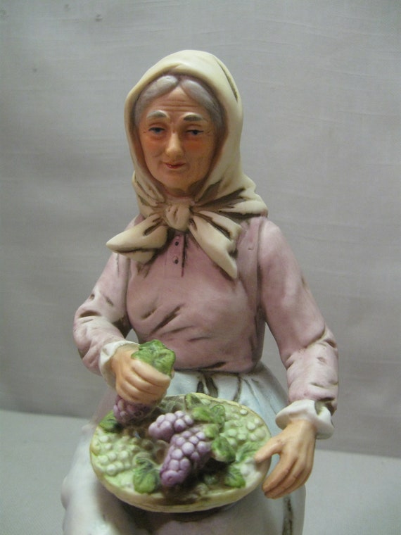 Figurine Bisque Porcelain Farm Woman Sitting With Basket of Grapes