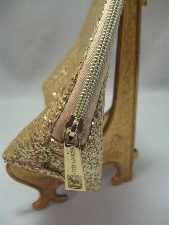 Estee lauder gold clutch deals
