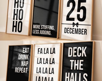 May include: Six framed art prints with black and white text. The prints feature phrases like "HO HO HO", "MORE STUFFING, LESS JUDGING", "25 DECEMBER", "EAT DRINK NAP REPEAT", "FA LA LA LA", and "DECK THE HALLS". The frames are a light brown color.