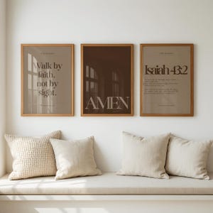 May include: Three framed art prints with inspirational quotes. The prints are in wooden frames and feature text in a neutral color palette. The first print says "Walk by faith, not by sight." The second print says "AMEN." The third print says "Isaiah 43:2."
