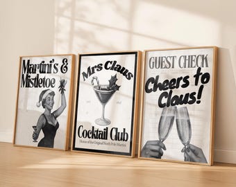 May include: Three framed vintage-style prints with a Christmas theme. The prints feature the text "Martini's & Mistletoe", "Mrs. Claus Cocktail Club", and "Cheers to Claus!". The prints are in black and white with gold frames.