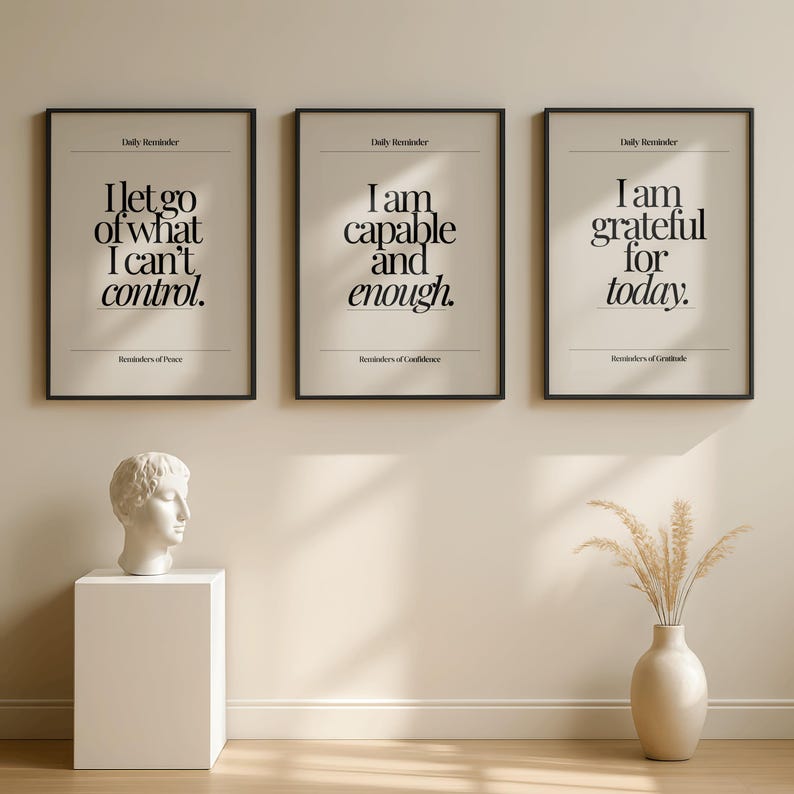 May include: Three framed prints with black frames and beige backgrounds. Each print features a different inspirational quote in black text: "I let go of what I can't control," "I am capable and enough," and "I am grateful for today."