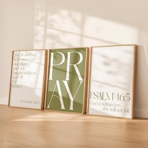 Puede incluir: Tres impresiones artísticas enmarcadas con citas inspiradoras. La primera impresión tiene el texto "She is clothed with strength and dignity. and she laughs without fear of the future. -Proverbs 31:25". La segunda impresión dice "PRAY". La tercera impresión dice "PSALM 46:5 God is within her, she will not fall."