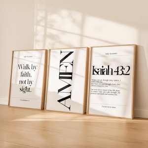 May include: Three framed art prints with inspirational quotes. The first reads "Walk by faith, not by sight." The second says "AMEN." The third features a Bible verse from Isaiah 43:2. All have a white background and a wooden frame.