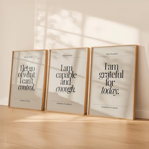 May include: Three framed art prints with inspirational quotes. The prints have a light beige background with black text. The first print reads "I let go of what I can't control." The second print reads "I am capable and enough." The third print reads "I am grateful for today."
