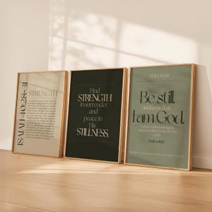 May include: Three framed art prints with inspirational quotes. The first print has text from Isaiah 40:28-31, the second says "Find Strength in surrender, and peace in His Stillness", and the third says "Be still and know that I am God."