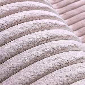 May include: Close-up of a soft, textured fabric in a light gray color. The fabric has a corduroy-like pattern with raised, rounded ridges running horizontally across the frame. The material appears plush and inviting, suggesting comfort and warmth.