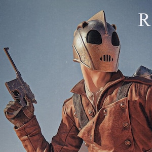 May include: A person in a brown leather jacket, helmet, and gloves, holding a gun, with the word "ROCKETEER" above. The image includes text about the Rocketeer being inspired by 1930s adventure serials.