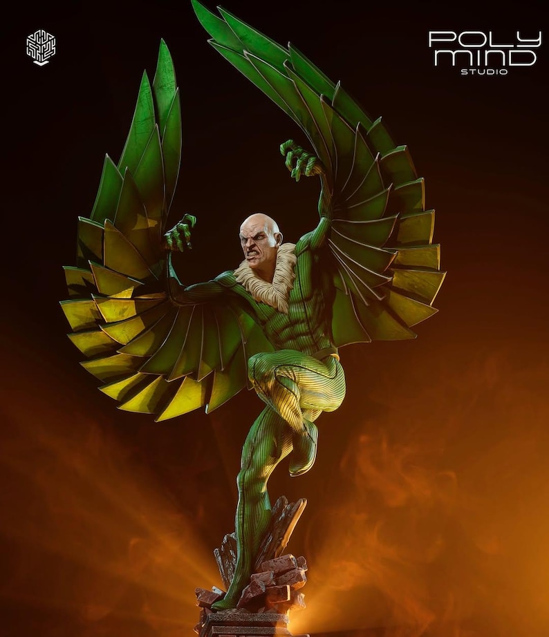 May include: A detailed statue of a comic book character, the Vulture, in a dynamic pose. The figure is predominantly green with yellow accents on the wings. The character is depicted with a bald head and a menacing expression. The statue is on a rocky base.
